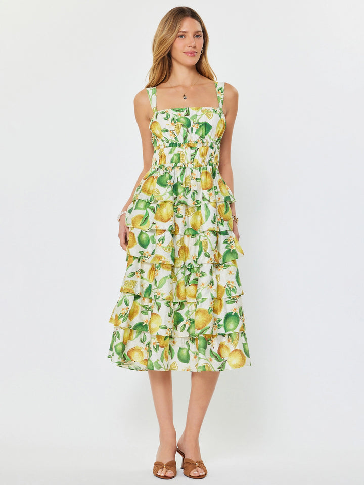 Woman wearing a lemon print dress on a white background
