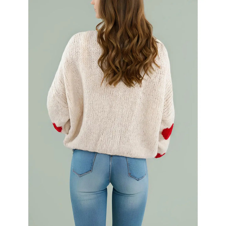 Cream tie front sweater with red hearts.