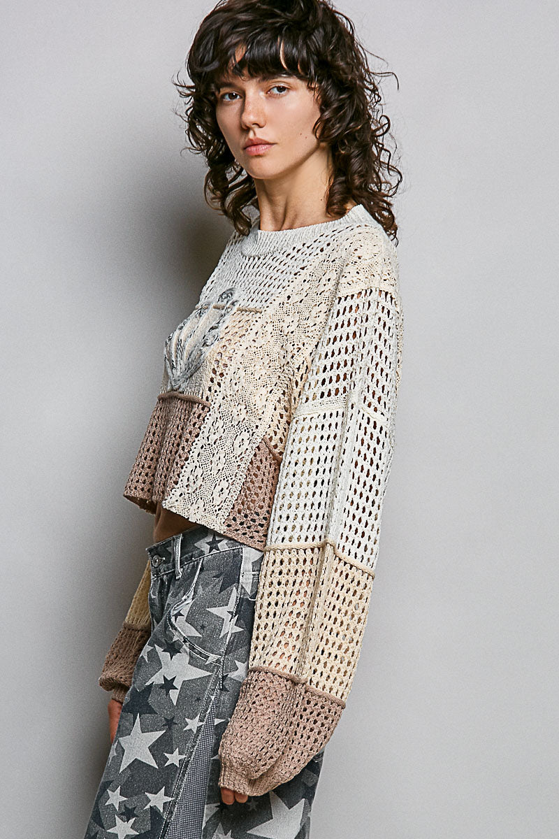 Woman wearing a textured, layered outfit with a neutral background
