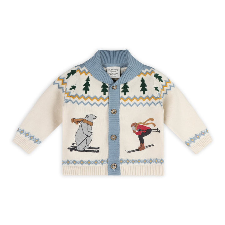 Alpine Snow Baby Cardigan in natural organic cotton knit with skiing figures and evergreen trees