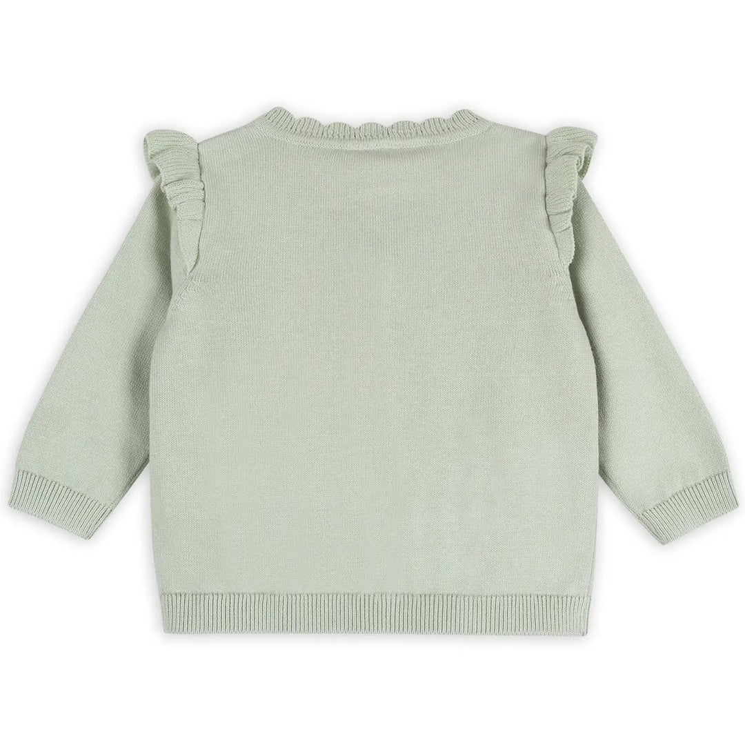 Light green sweater with ruffled shoulders on a white background