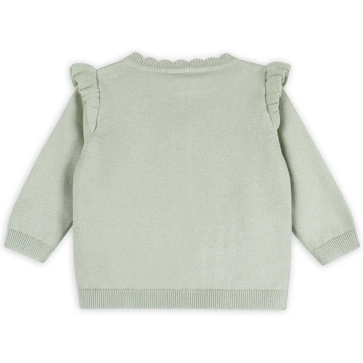 Light green sweater with ruffled shoulders on a white background