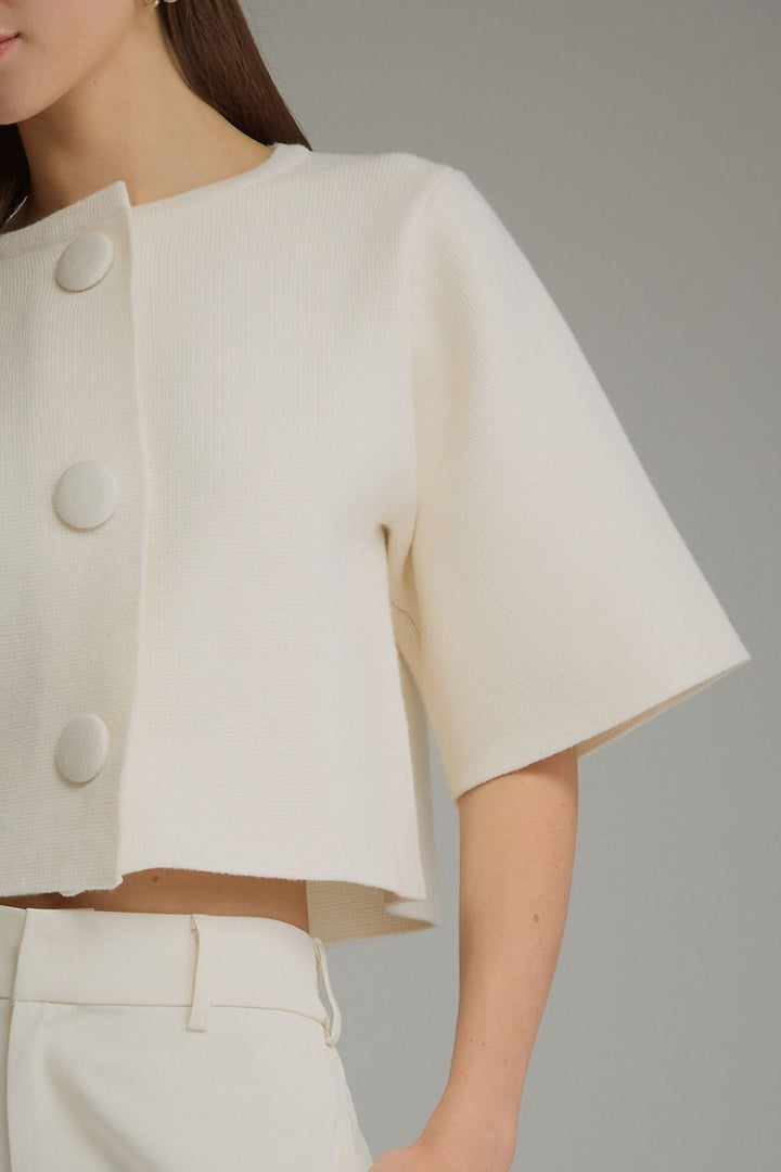 Bianca Button Cardigan in cream, close-up of covered buttons and sleeve