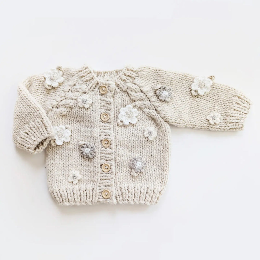 Natural hand-knit Blossom Baby Cardigan with crocheted flowers, cabled raglan sleeves and wood buttons