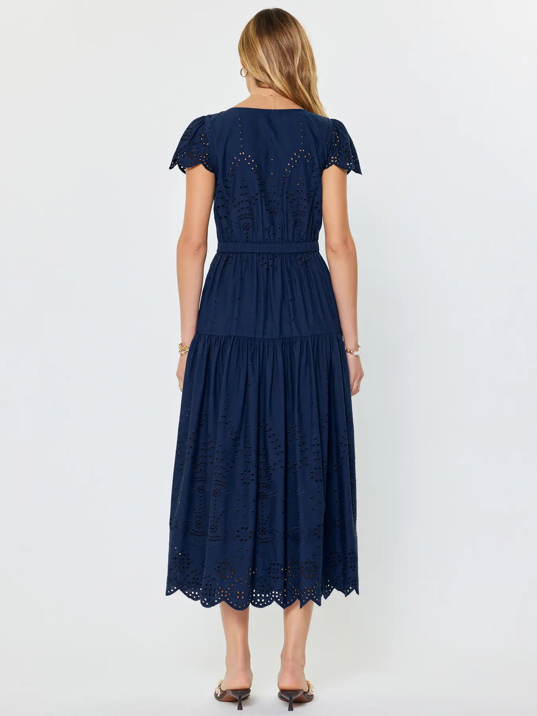 Navy blue dress with lace details on a white background