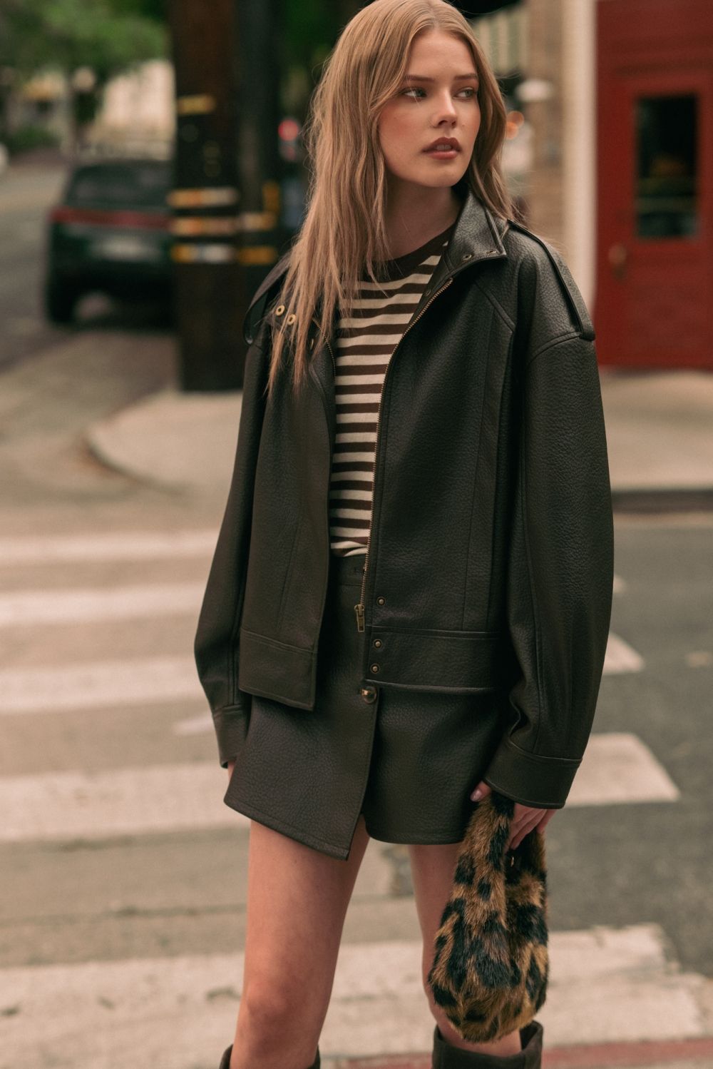 Chocolate Faux Leather Skort in chocolate brown, lifestyle front view with the matching jacket