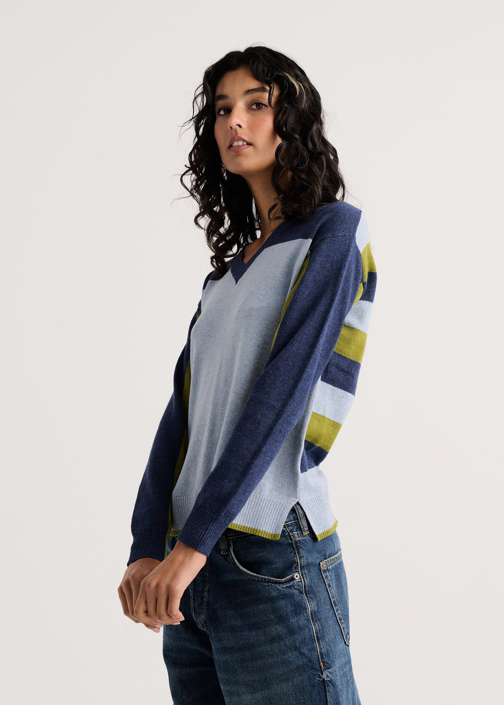 Color Theory V-Neck Sweater side view showing navy sleeve and striped back