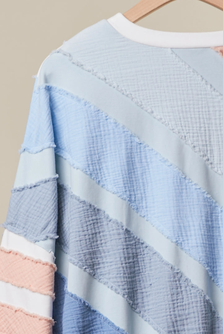Textured fabric with blue, pink, and white stripes on a beige background