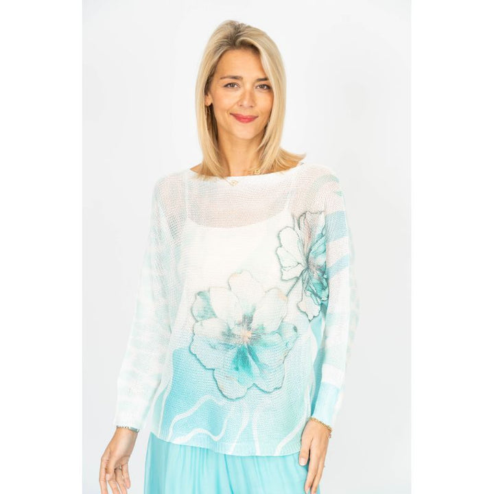 Woman wearing a light blue floral top with a white background