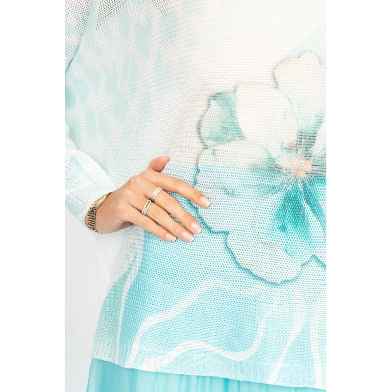 Light blue floral dress with a hand wearing a ring on a white background