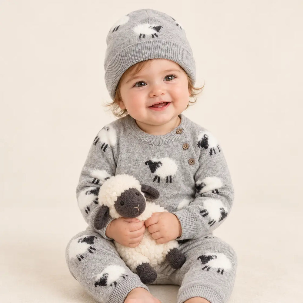 Baby wearing the Furry Sheep Baby Beanie with matching sheep jumpsuit