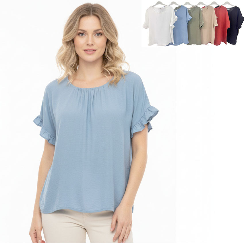 Woman wearing a light blue blouse with a row of similar blouses in various colors on a white background.