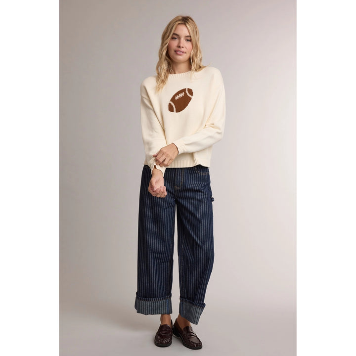 Game Day Football Sweater in cream, full-length view styled with pinstripe jeans