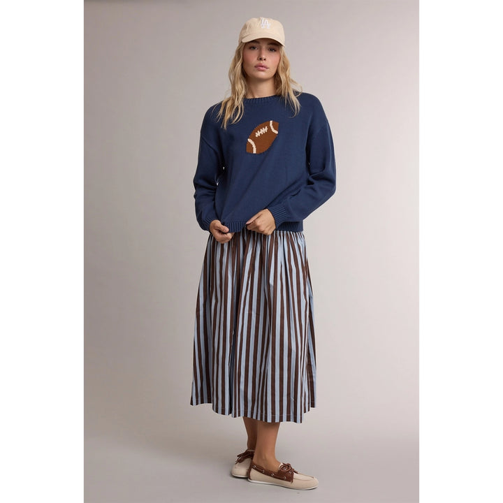 Game Day Football Sweater in navy, full-length view styled with a striped pleated skirt