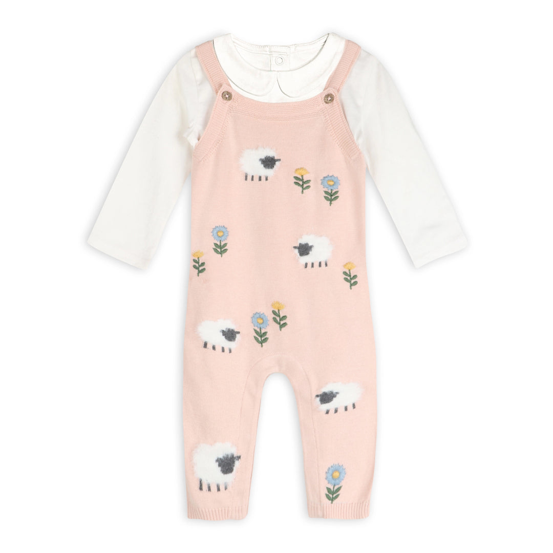 Pink knit baby overalls with lamb and floral pattern over a white long-sleeve bodysuit romper