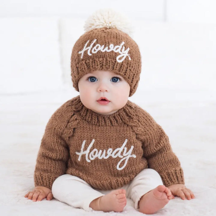 Baby wearing the pecan Howdy Baby Sweater with matching Howdy Baby Hat