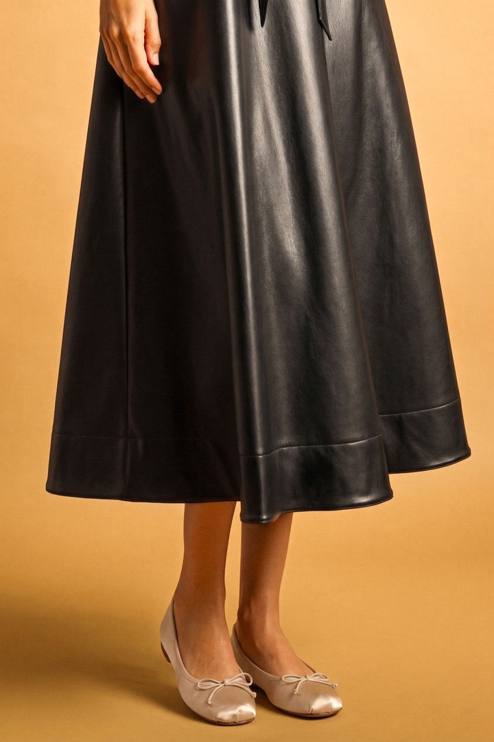Laurel Belted Faux Leather Dress in black, close-up of A-line midi skirt
