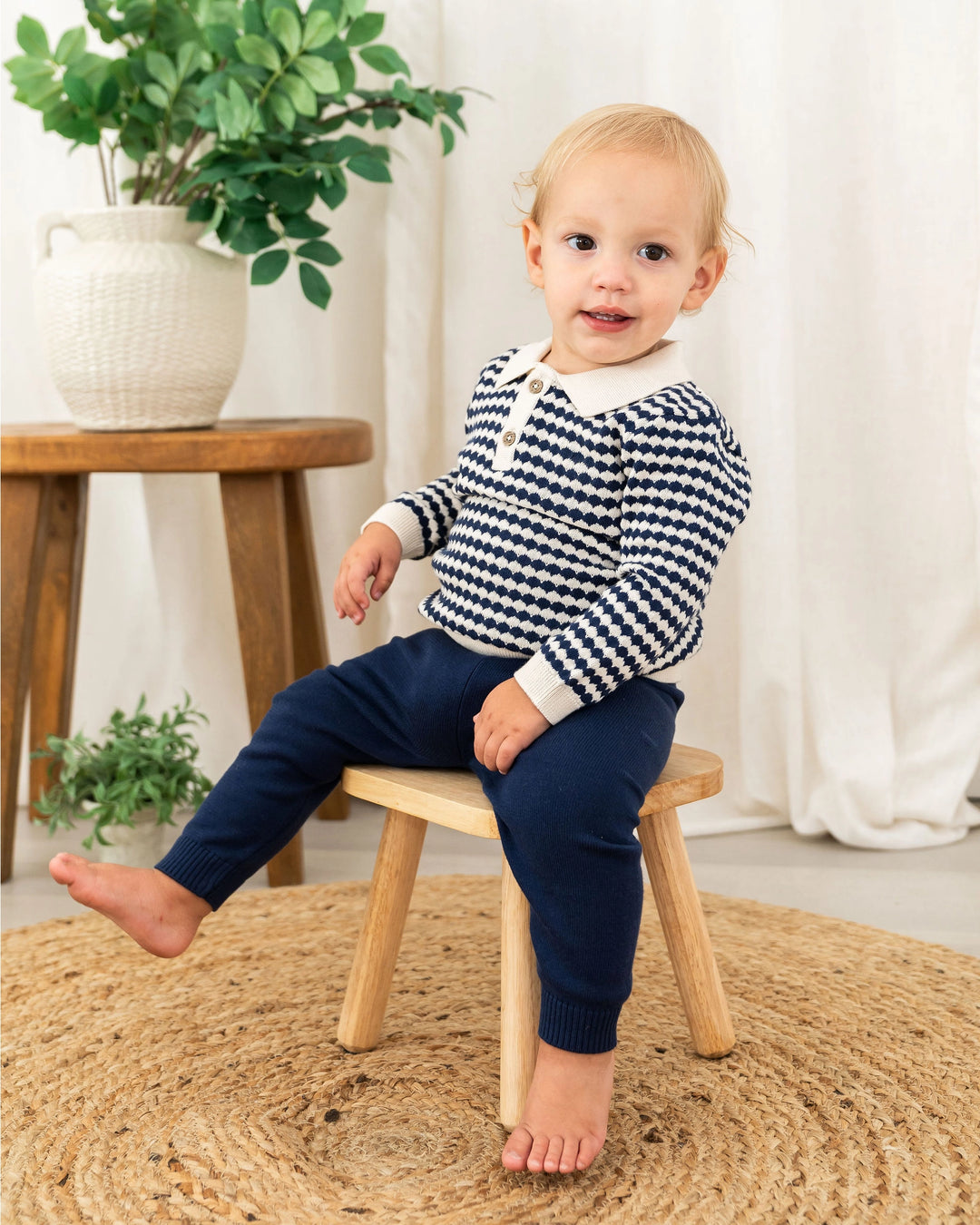 Textured wavy knit pattern detail on navy baby polo pullover