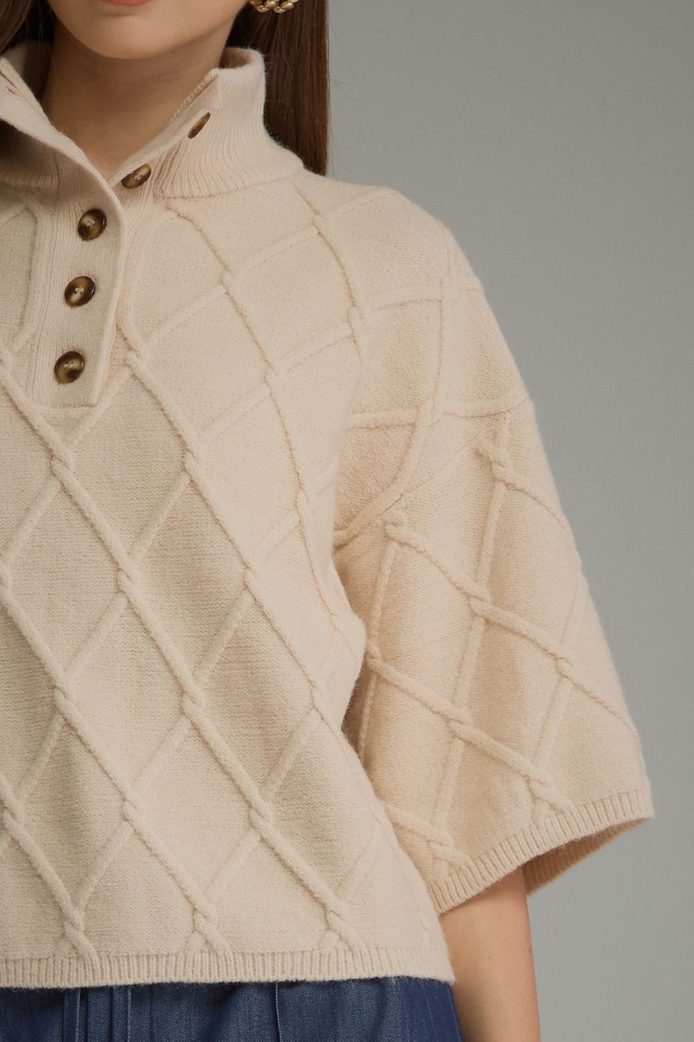 Liesel Cable Sweater in ecru, close-up of button placket and diamond cable knit