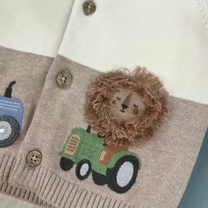 Lion driving a farm truck motif on navy organic cotton baby jacket