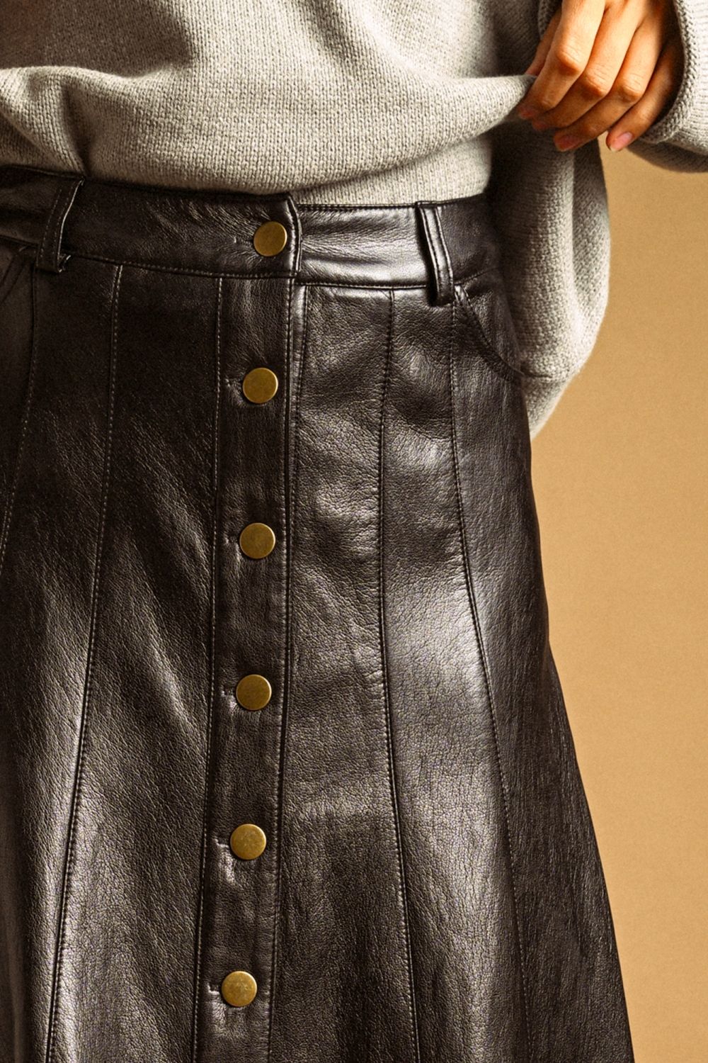 Maxine Faux Leather Skirt in black, close-up of button front and paneled seams