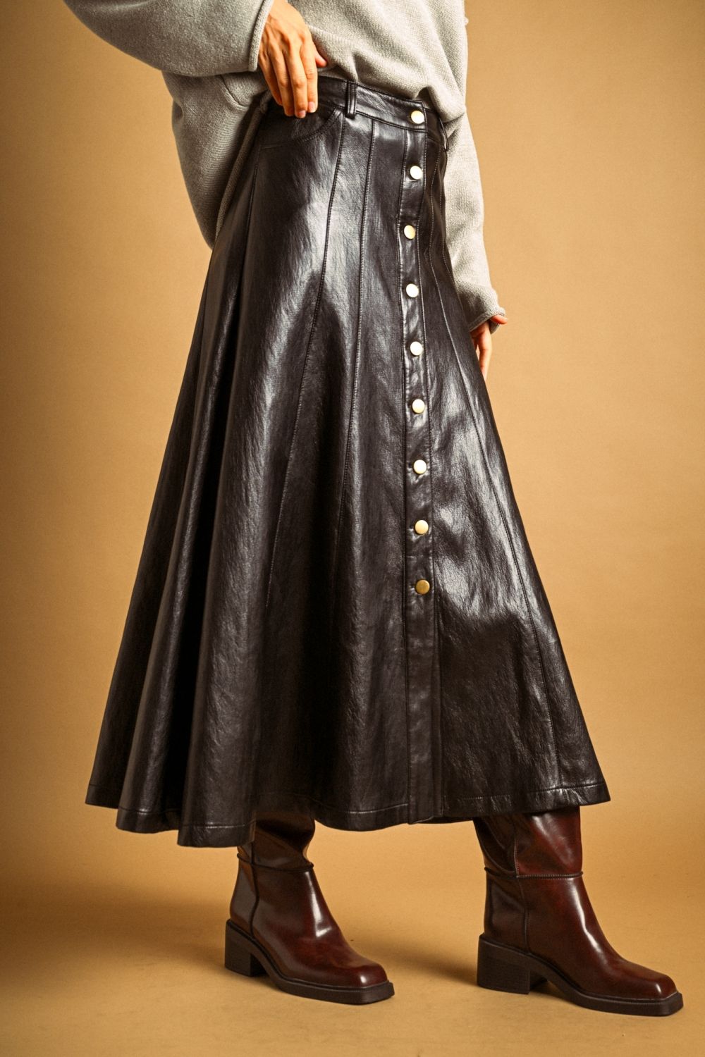 Maxine Faux Leather Skirt in black, front view styled with ankle boots