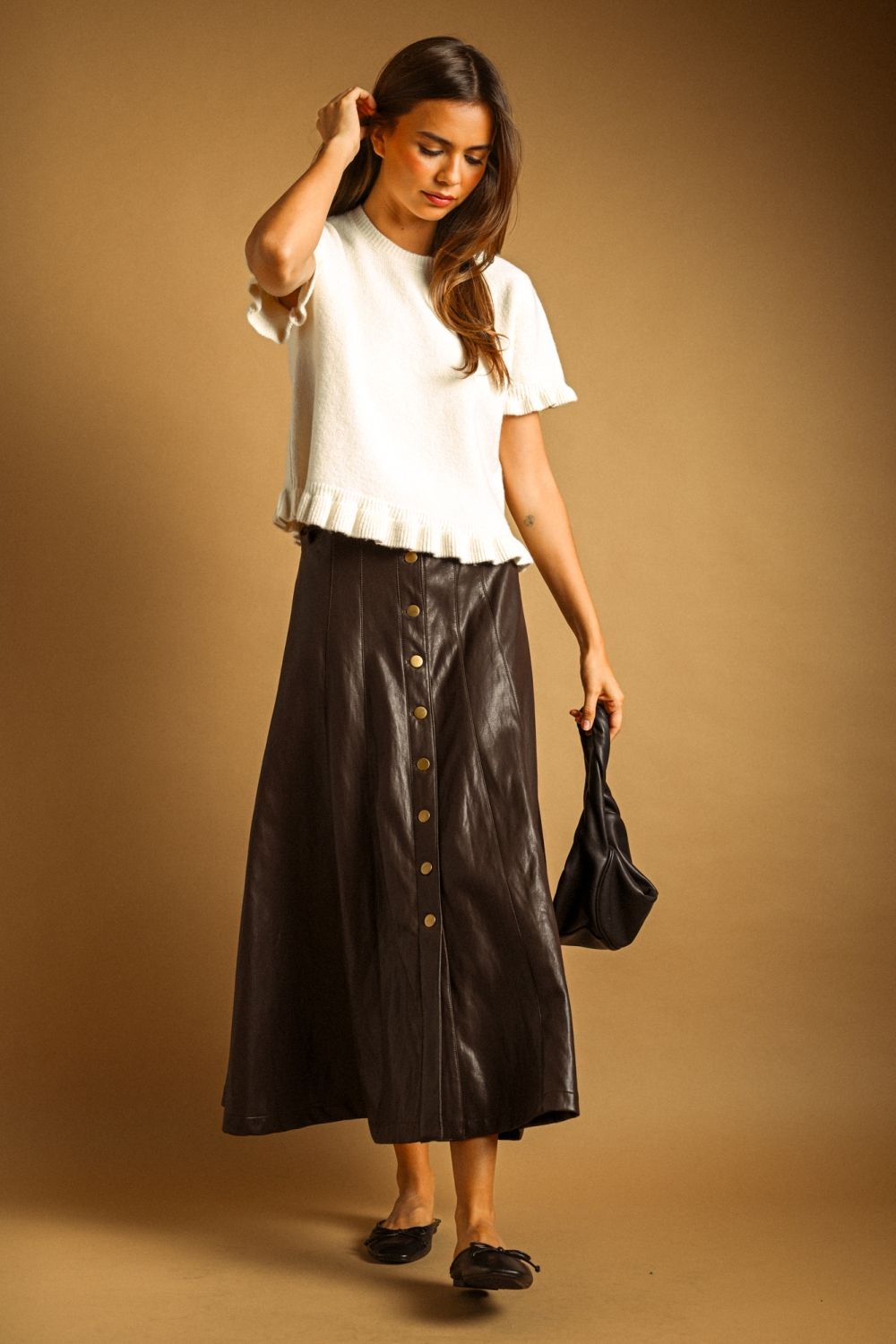 Maxine Faux Leather Skirt in black, full-length view styled with a white knit top