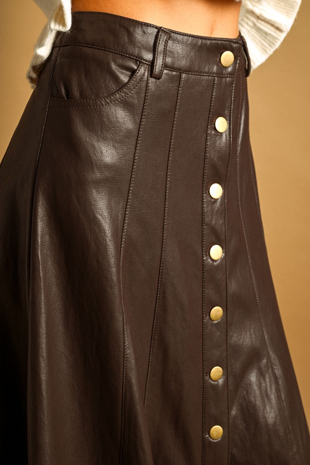 Maxine Faux Leather Skirt in brown, close-up of button front and front pocket