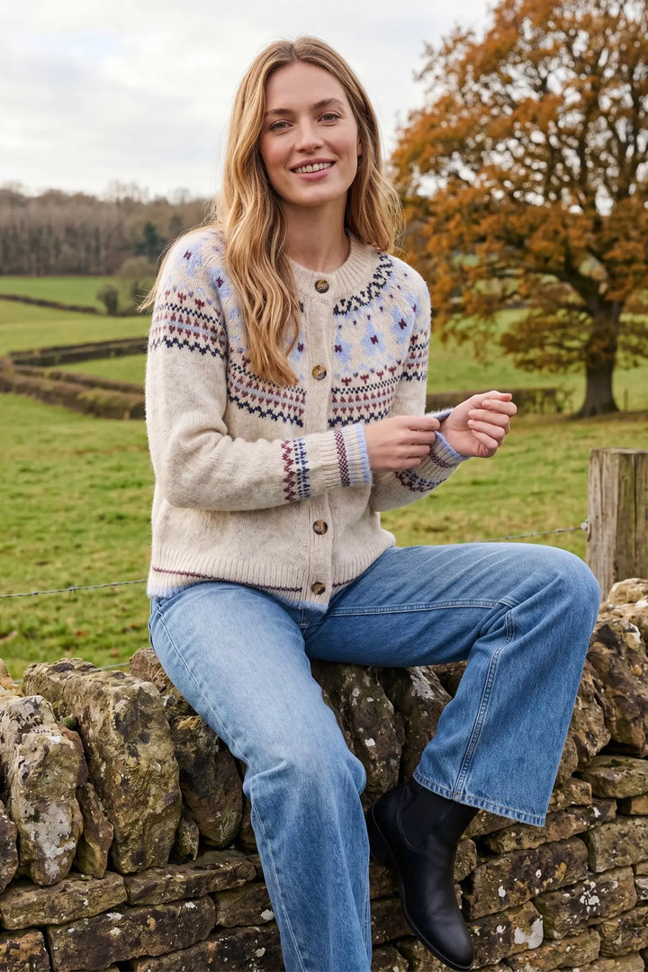 Nordic Nights Cardigan in cream, lifestyle view styled with jeans outdoors