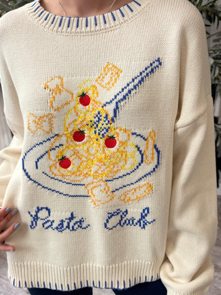 Cream-colored knit sweater featuring a colorful graphic of spaghetti, tomatoes, and a fork with the text &