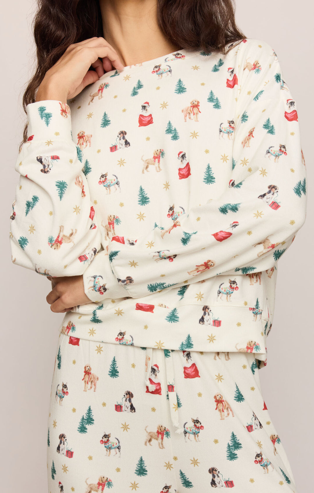 Close-up of the Pawfect Pajama Top dog print with pups in Santa hats, Christmas trees, and gifts