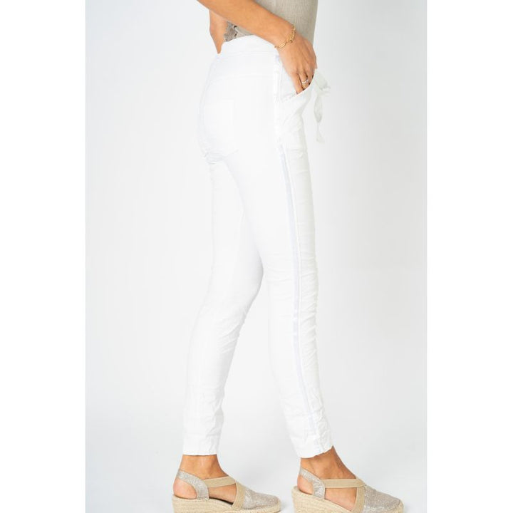 White pants worn by a person on a white background