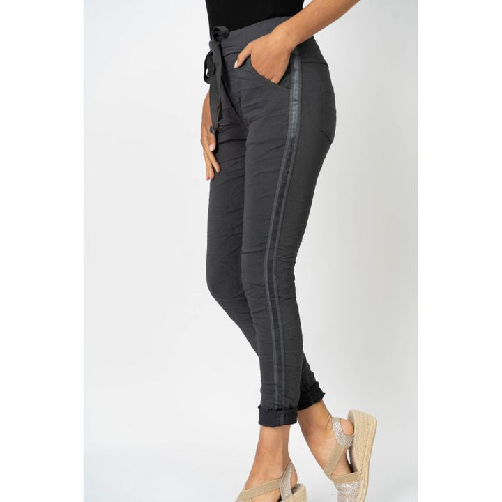 Gray pants with a subtle pattern worn by a person on a white background