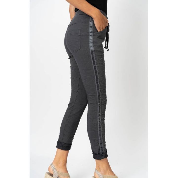 Gray jogger pants with side stripes on a white background