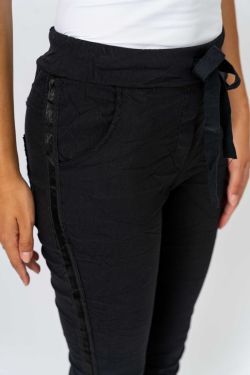 Black apron worn by a person on a white background