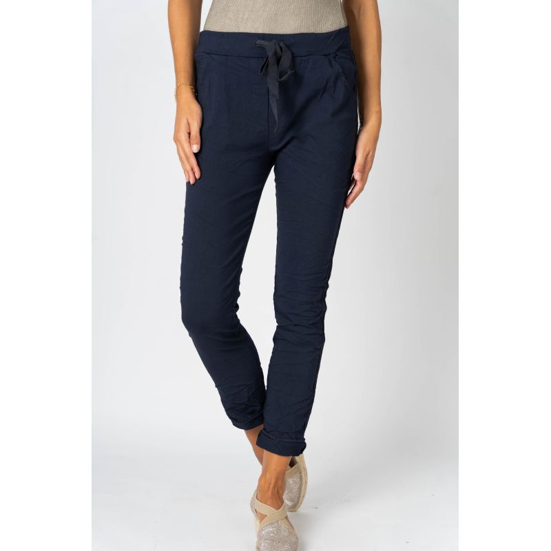 Navy blue pants worn by a person on a white background