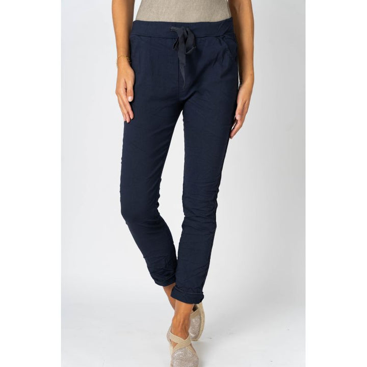 Navy blue pants worn by a person on a white background