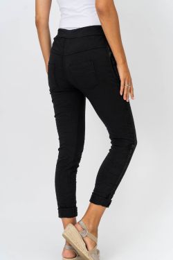 Person wearing black pants on a white background