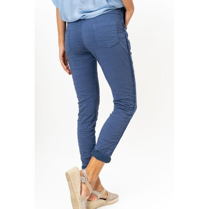 Person wearing blue pants on a white background