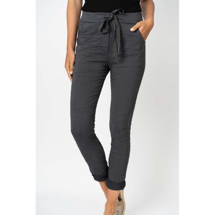 Dark gray jogger pants worn by a person on a white background