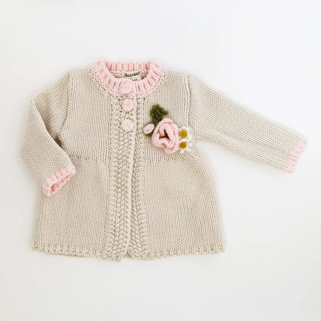 Natural hand-knit Poppy Bloom Baby Cardigan swing sweater with pink trim and a mohair poppy appliqué
