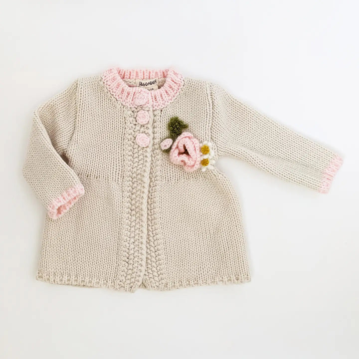 Natural hand-knit Poppy Bloom Baby Cardigan swing sweater with pink trim and a mohair poppy appliqué