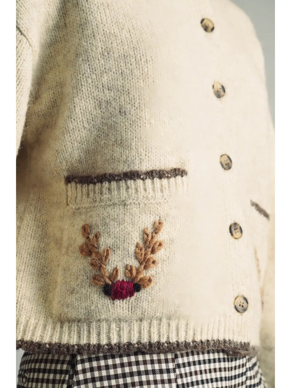 Reindeer Games Pocket Cardigan in oatmeal with brown trim, close-up of embroidered reindeer antler pocket