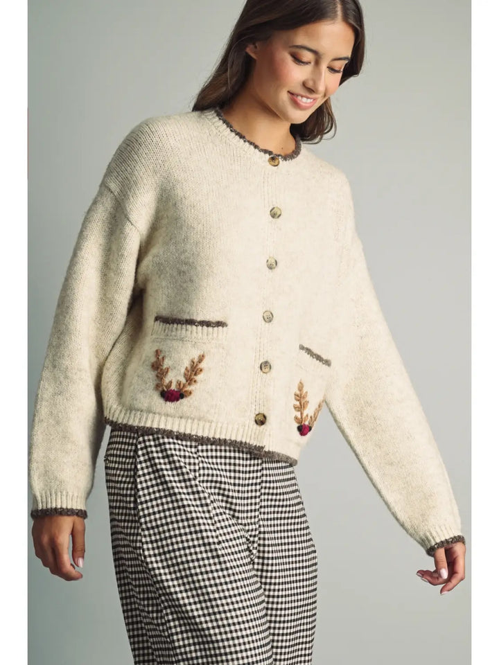 Reindeer Games Pocket Cardigan in oatmeal with brown trim, three-quarter front view