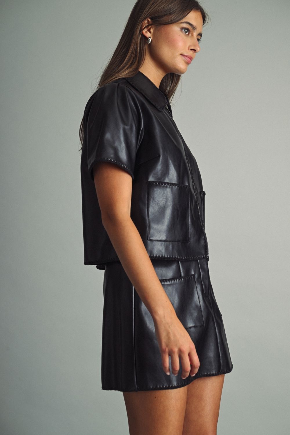 Rhodes Faux Leather Zip Top in black, side view showing patch pocket