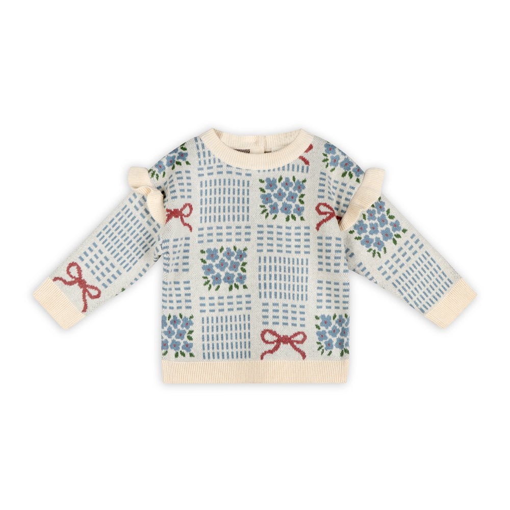 Ecru baby jacquard sweater with blue floral bouquets, red ribbon bows, ruffle shoulders, and cream ribbed trim