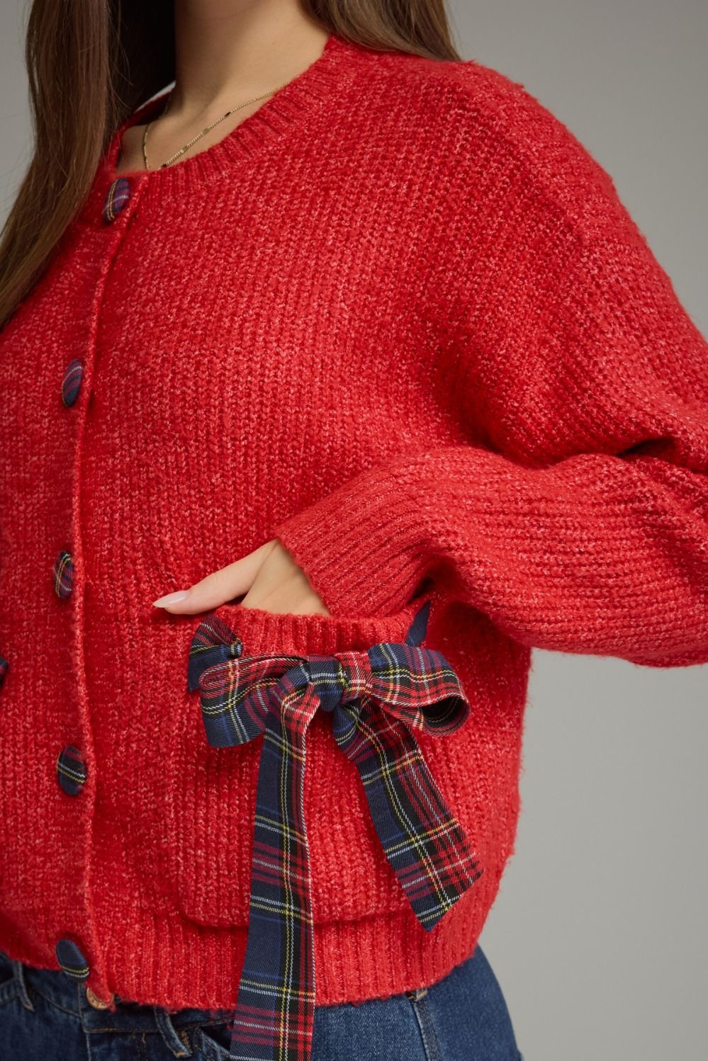 Tied Up in Tartan Bow Cardigan in red, close-up of plaid bow pocket and tartan buttons
