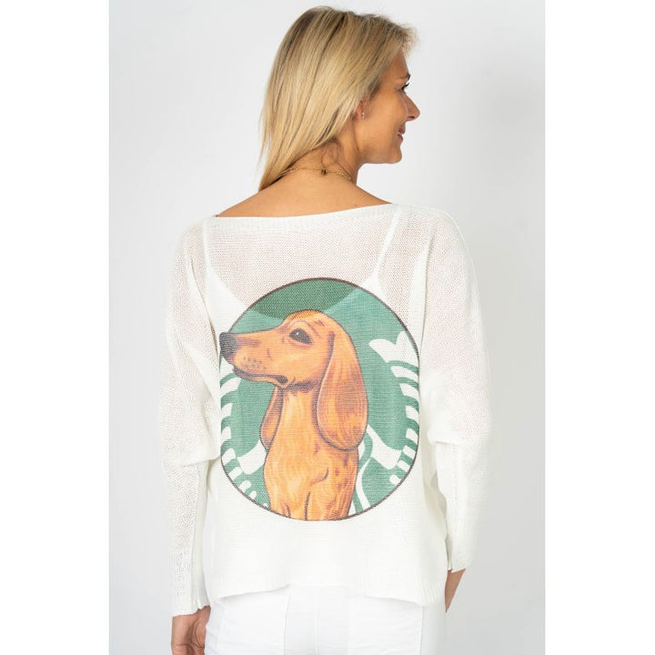 Woman wearing a white long-sleeve shirt with a dachshund graphic on the back against a plain background