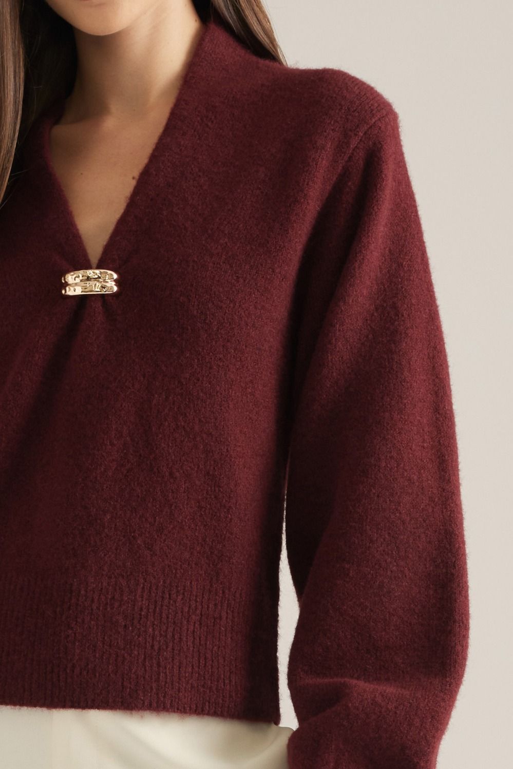 Vivienne Gold Clasp Collared Sweater in burgundy, close-up of gold clasp V-neckline