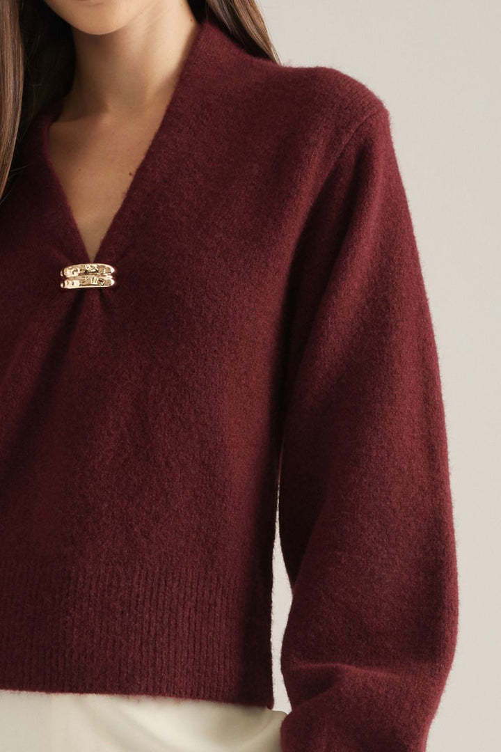 Vivienne Gold Clasp Collared Sweater in burgundy, close-up of gold clasp V-neckline